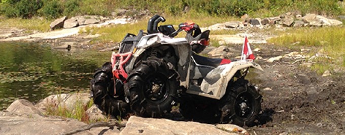 RangerBob going thru a lake while on the Park to Park Trail system in Parry Sound